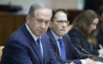 Israeli Prime Minister Benjamin Netanyahu, left, attends the weekly cabinet meeting at his office in Jerusalem, Sunday, Jan. 8, 2017. (Abir Sultan, Po