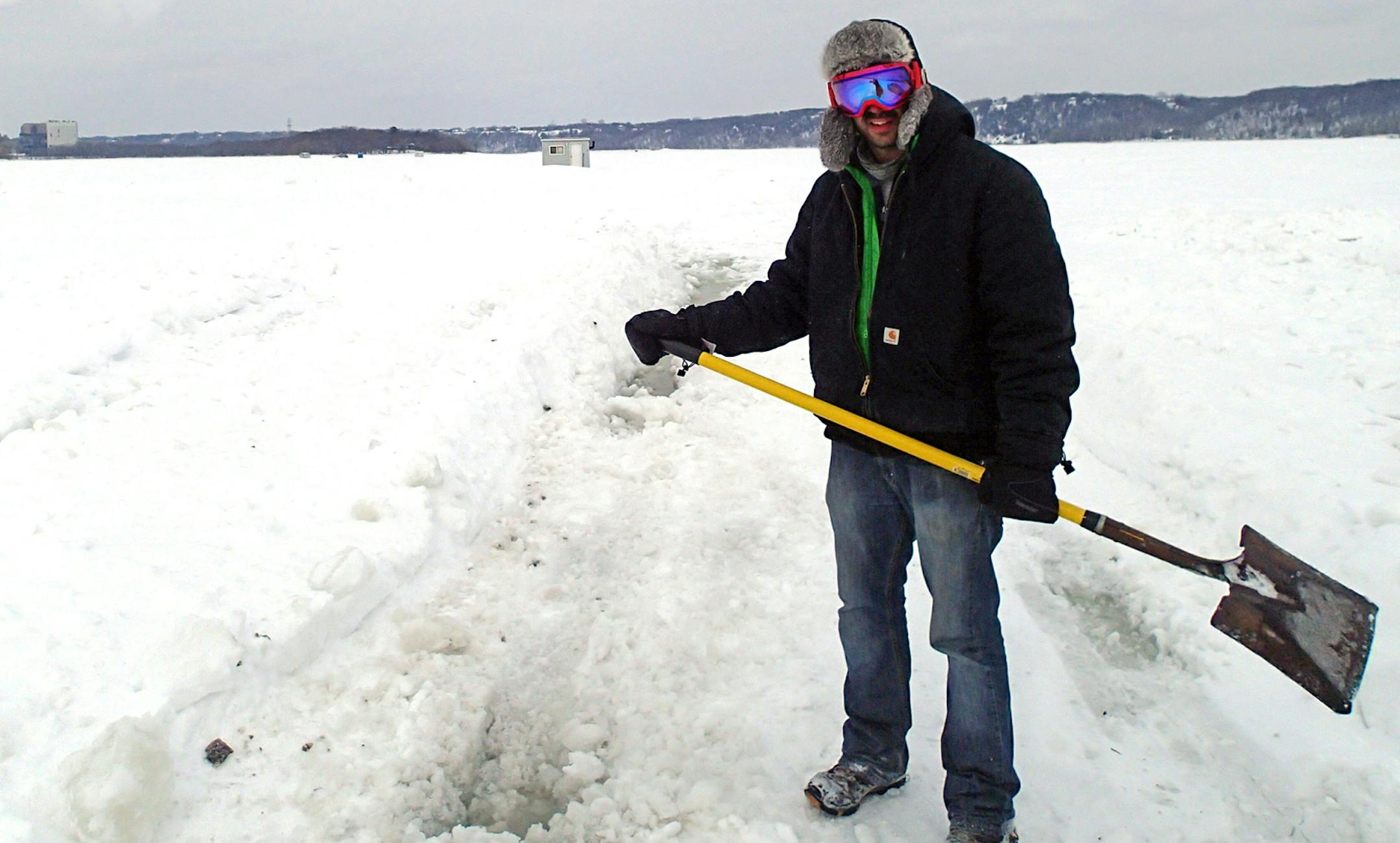Kyle Thompson of Cottage Grove shoveled his way through slush Friday on the St. Croix.