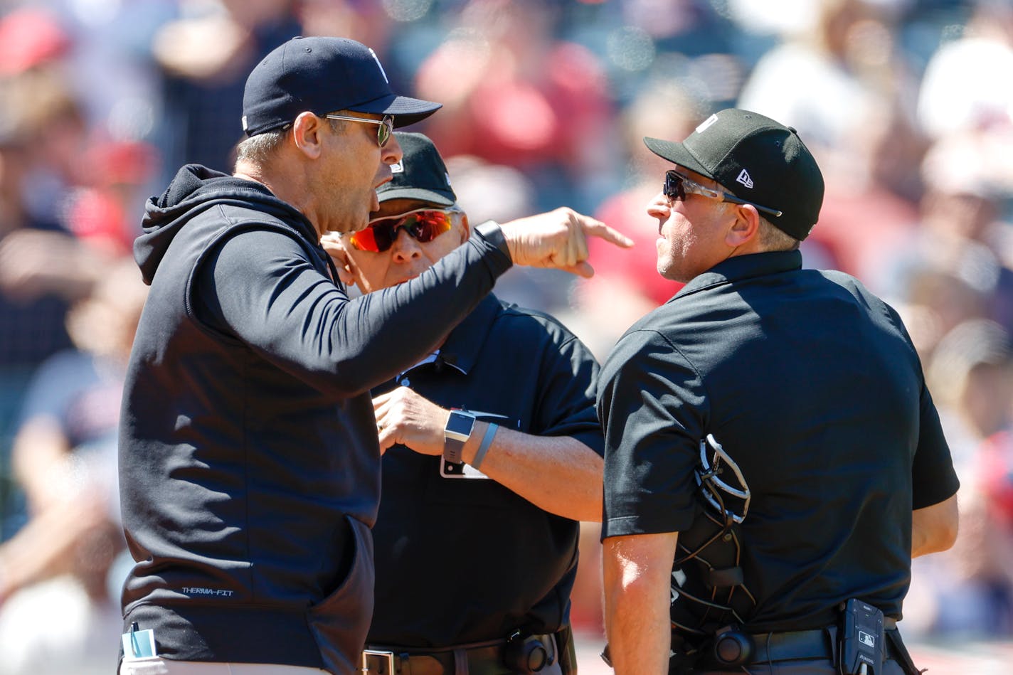 Aaron Boone, left, of the New York Yankees argues a review call with home plate umpires Chris Guccione, right, and Larry Vanover, after being ejected from the game during the first inning at Progressive Field on April 12, 2023, in Cleveland, Ohio. (Ron Schwane/Getty Images/TNS) ORG XMIT: 76645768W