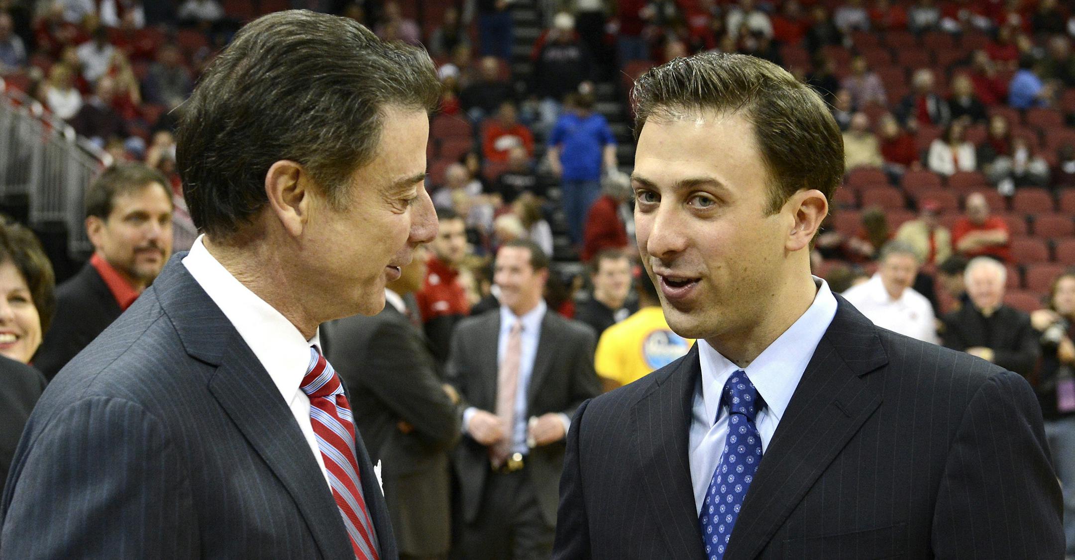 Louisville coach Rick Pitino, left, shakes hands with his son Richard Pitino, right, coach of Florida International, before their NCAA college basketball game on Wednesday, Dec. 19, 2012, in Louisville, Ky. (AP Photo/Timothy D. Easley) ORG XMIT: KYTE102