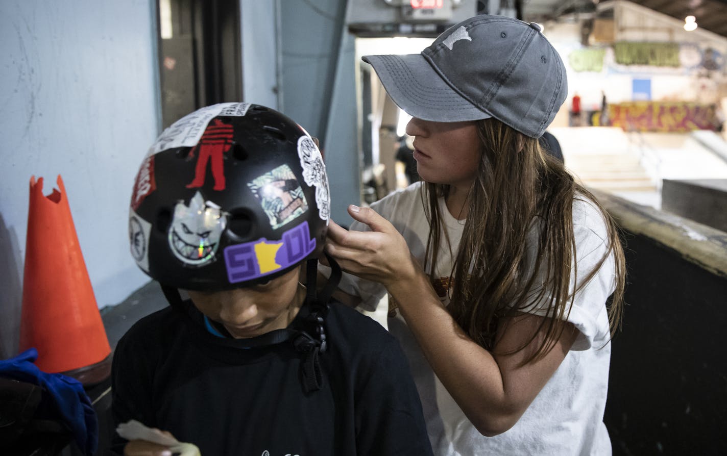 Nicole Hause of Stillwater, left, signed Emmanuel Robinson's helmet at 3rd Lair Skate Park last month.