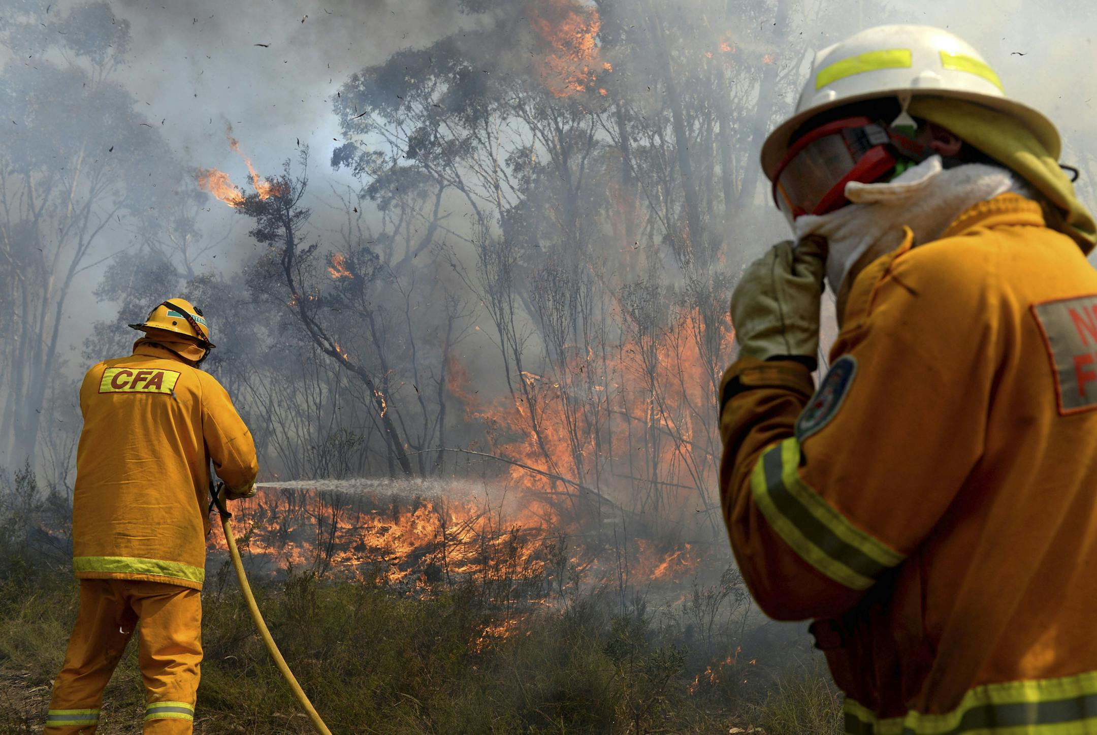 Firefighters work on putting in containment lines to help control a wildfire near the township of Bell, Australia, Monday, Oct. 21, 2013. Authorities warned that high temperatures and winds were likely to maintain heightened fire danger for days. (AP Photo/AAP Image, Dan Himbrechts) NO ARCHIVING, AUSTRALIA OUT, NEW ZEALAND OUT, PAPUA NEW GUINEA OUT, SOUTH PACIFIC OUT, NO SALES