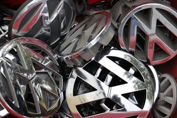 FILE - In this Sept. 23, 2015 file photo Volkswagen ornaments sit in a box in a scrap yard in Berlin, Germany. A German court says Wednesday, Sept. 21