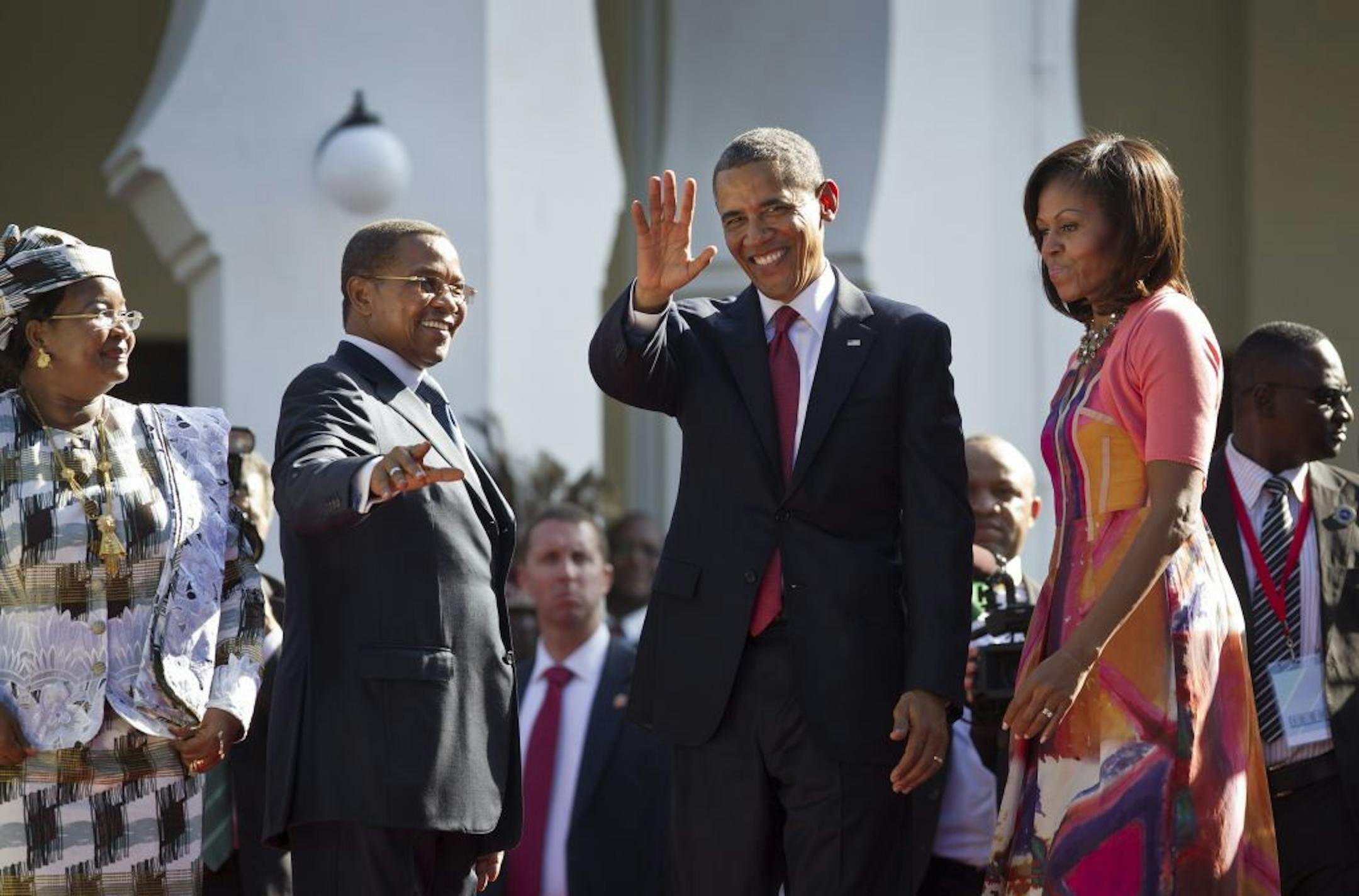 U.S. President Barack Obama, center-right, first lady Michelle Obama, right, Tanzanian President Jakaya Kikwete, center-left, and Tanzanian First Lady Salma Kikwete, left, arrive at State House in Dar es Salaam, Tanzania Monday, July 1, 2013. Teeming crowds and blaring horns welcomed President Barack Obama to Tanzania's largest city, where the U.S. president's likeness is everywhere as he arrived on the last leg of his three-country tour of the African continent.