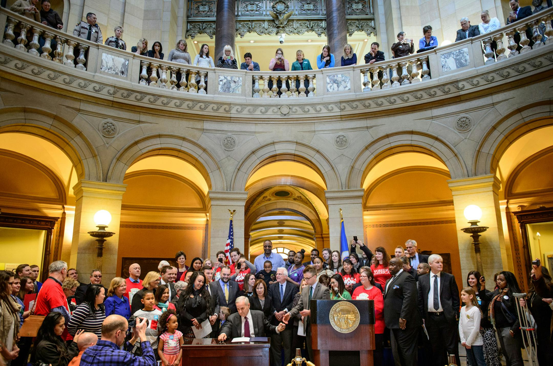 Gov. Mark Dayton signed the minimum wage bill into law at a ceremony Monday, April 14, 2014, in the Minnesota State Capitol rotunda. The bill increases Minnesota's minimum wage to $9.50 per hour, and indexes it to inflation.