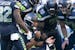 Seattle Seahawks quarterback Russell Wilson breaks the huddle during the second half of an NFL football game against the Dallas Cowboys, Sunday, Sept.