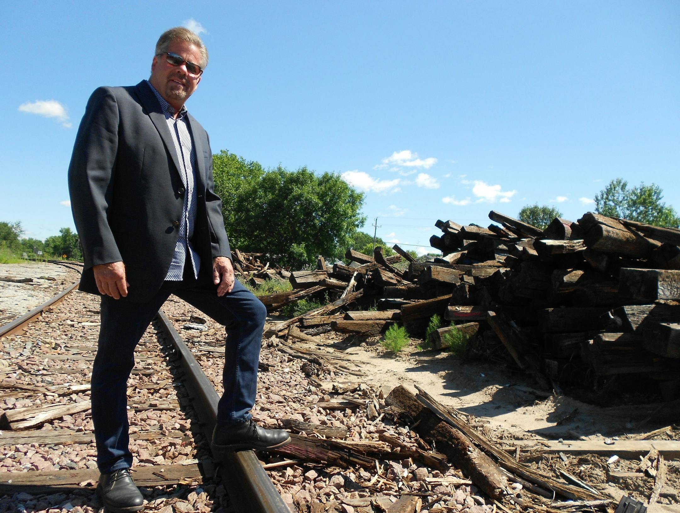John Schweiters, president and owner of J.L. Schweiters Construction Inc., at the rail spur leading into his company. The line is being rebuilt by Minnesota Commercial Railway after receiving bonding funds from the Legislature in 2016.