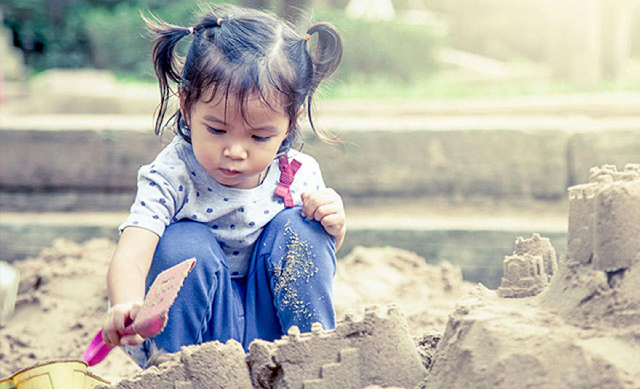 Girl playing in the sandbox at Minnesota Zoo.