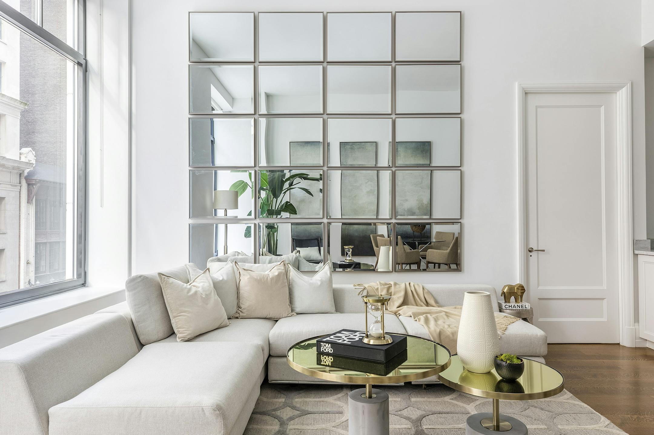 Simple mirrors trimmed in silver make a powerful statement when placed in a large grid.