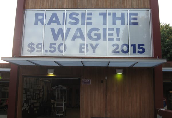 A sign at the Minnesota State Fair urges lawmakers to raise the minimum wage.