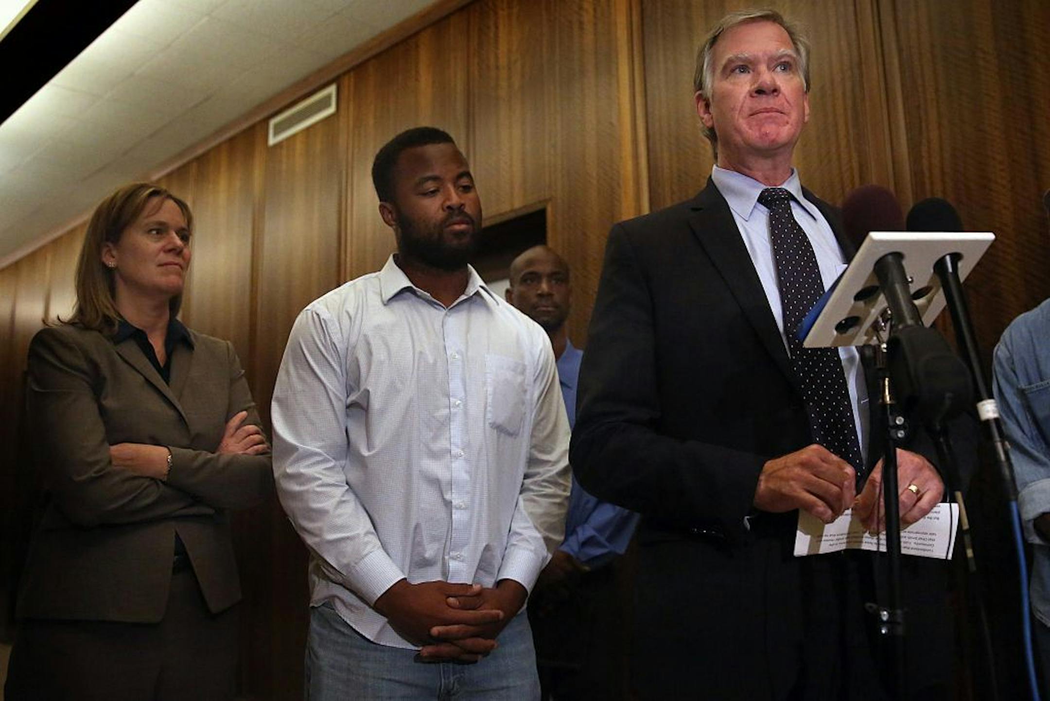 Rashad Turner, second from left, the leader of the St. Paul chapter of Black Lives Matter, joins St. Paul Mayor Chris Coleman, right, and Saint Paul Deputy Mayor, Kristin Beckmann during a news conference following a meeting Thursday morning, Oct. 1, 2015, at the mayor�s office in St. Paul, Minn. The St. Paul chapter's plan to protest at the Twin Cities Marathon has sparked division and raised alarm among an estimated 11,000 runners about potential conflicts at the finish line. Turner says the g