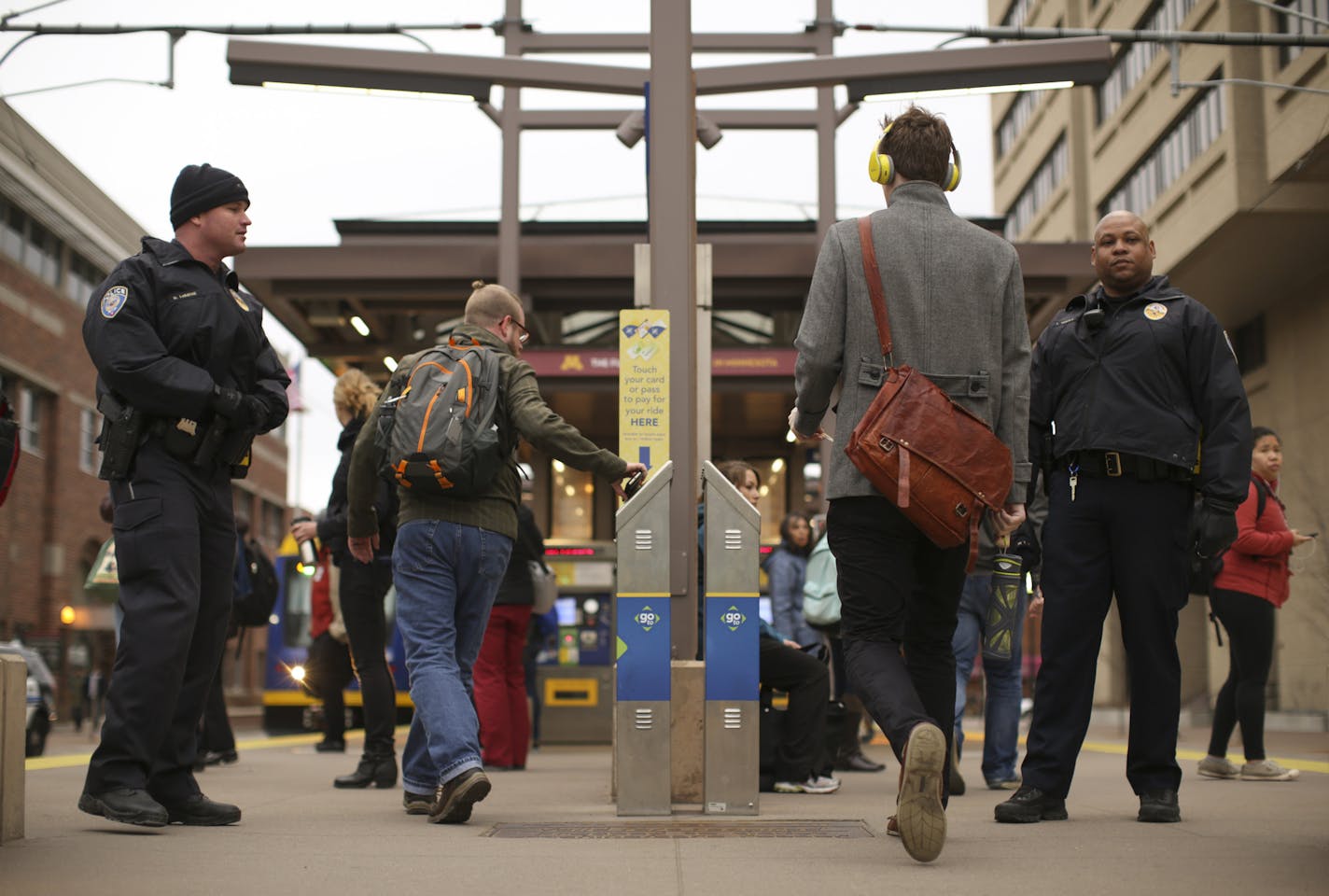 Transit officers Noah LaBathe, left, and LaFayette Temple checked for valid passes or receipts from riders at the East Bank Station Tuesday afternoon in Minneapolis. ] JEFF WHEELER &#x2022; jeff.wheeler@startribune.com A new report shows that light rail fare dodgers cost the Met Council about $28,000 a week in lost revenues. Riders rarely see anyone checking for compliance, but Tuesday afternoon, April 7, 2015 Transit Police were at the East Bank station at the U of M asking for proof of payment