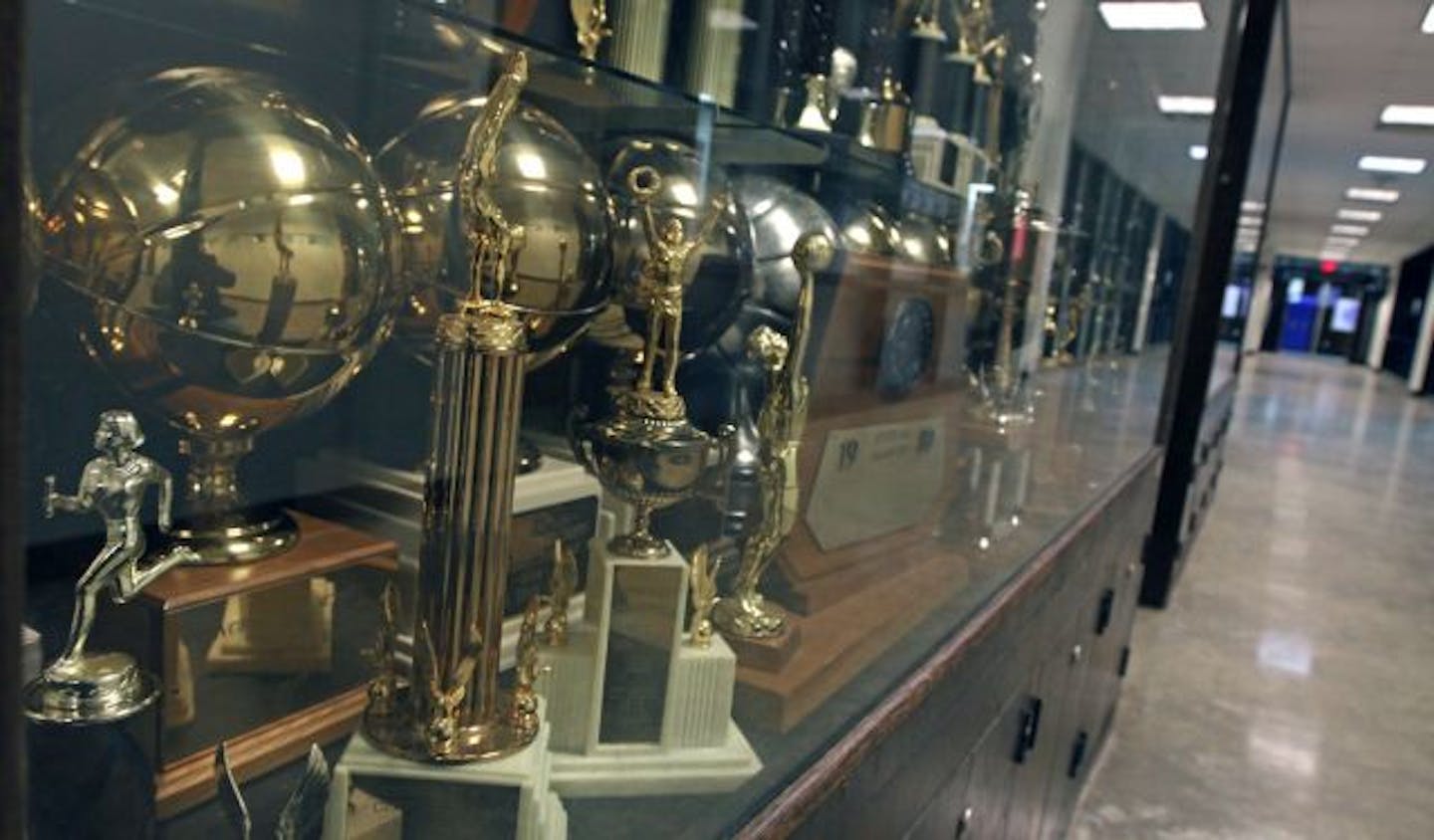 The trophy cases next to the gym are filled with trophies from past championships. A banner over the main entrance at the North High gym touts past boys and girls basketball championships in 2003.