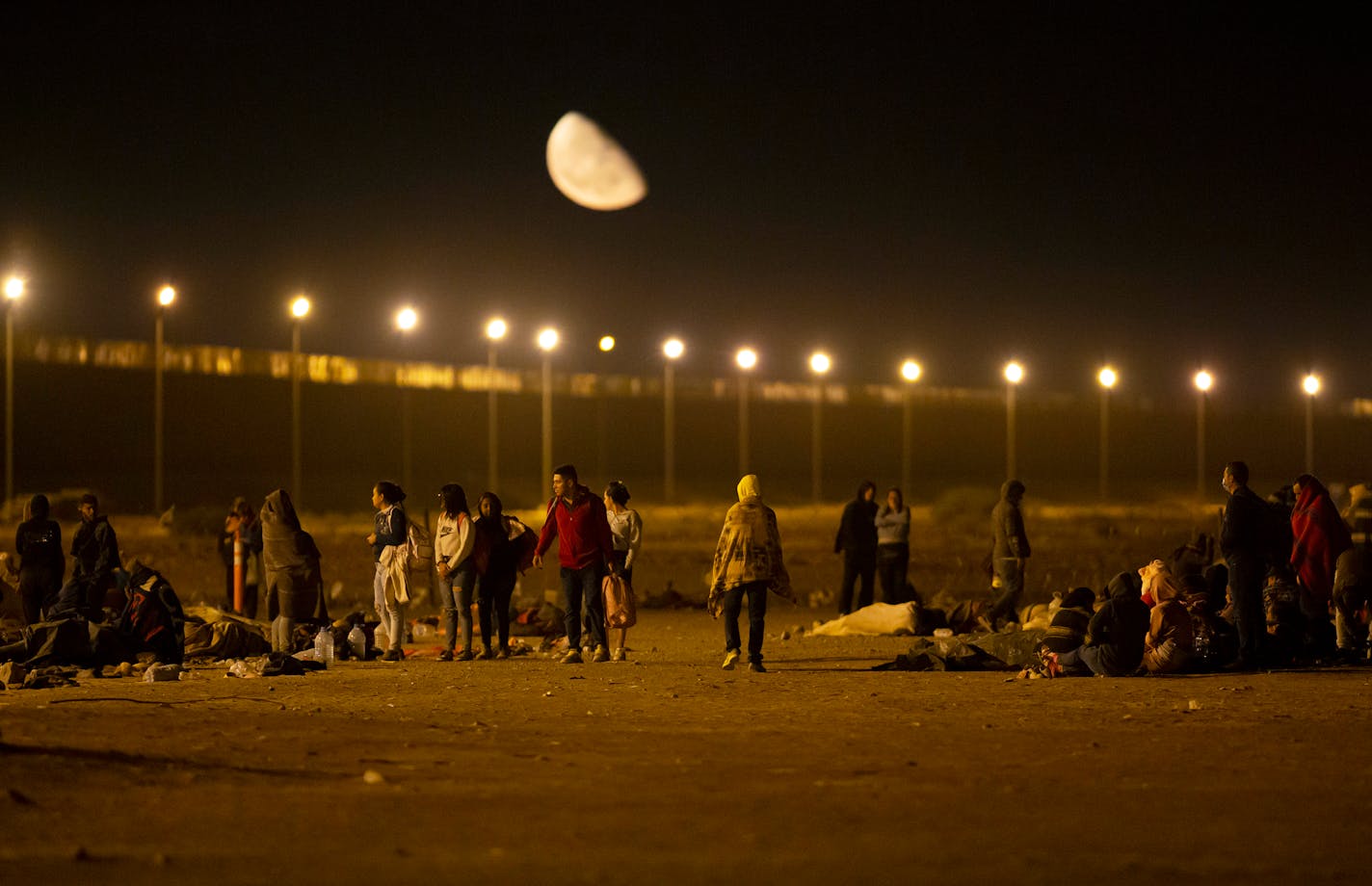 Migrants arrive at a gate in the border fence after crossing from Ciudad Juarez, Mexico into El Paso, Texas, in the early hours of Thursday, May 11, 2023. Migrants rushed across the border hours before pandemic-related asylum restrictions were to expire Thursday, fearing that new policies would make it far more difficult to gain entry into the United States.