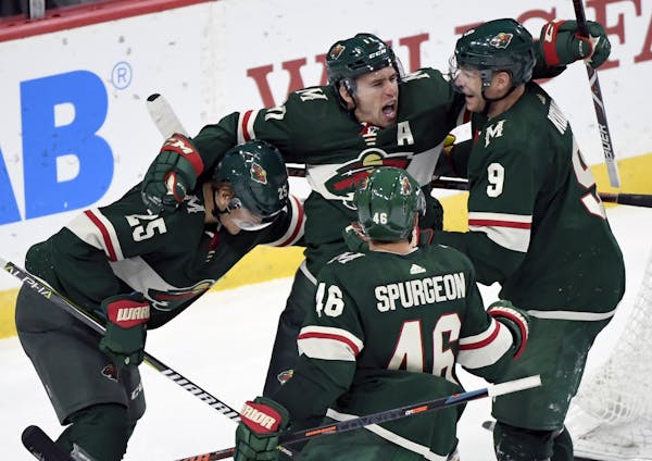 The Wild's Jonas Brodin (25), Jared Spurgeon (46), Zach Parise (11) and Mikko Koivu (9 celebrate a goal by Parise against the Tampa Bay Lightning in O