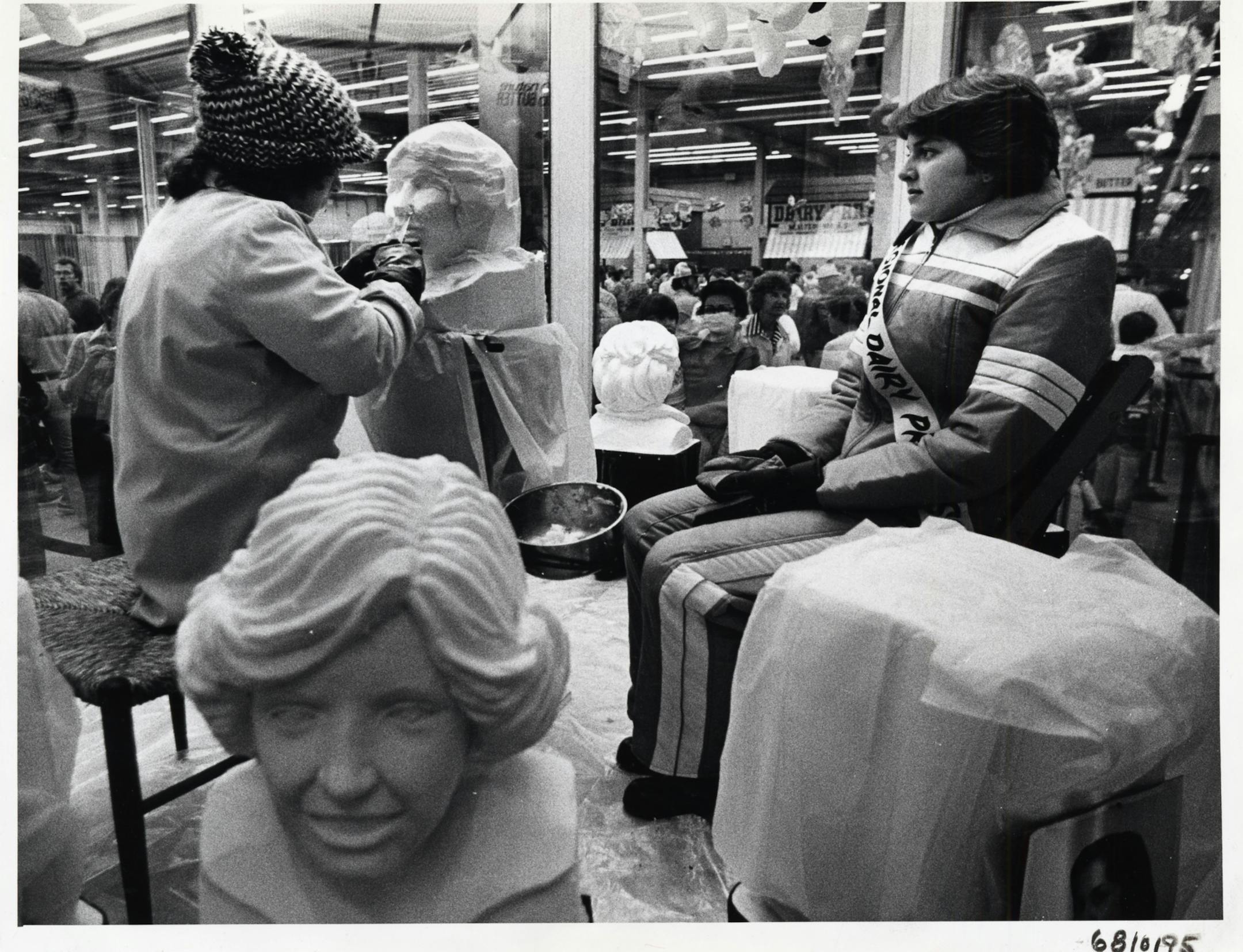 Denise Hermanson, dairy princess from Region 6, modeled Tuesday for Linda Christensen. A finished butter sculpture was in the foreground. (1978 photo)