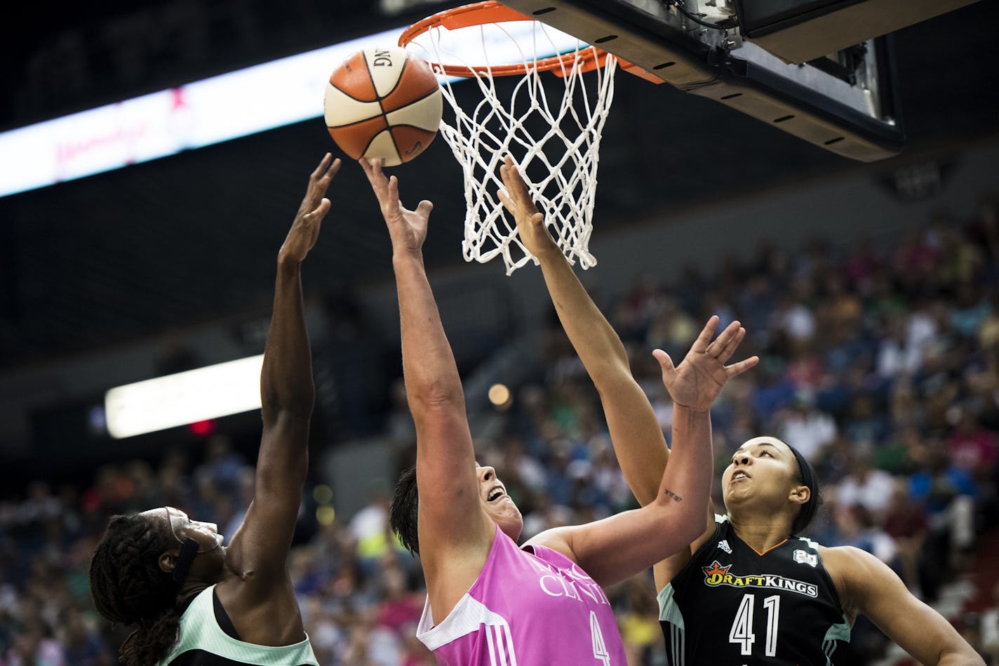 Minnesota Lynx center Janel McCarville (4) shot while contested by New York Liberty center Kiah Stokes (41).