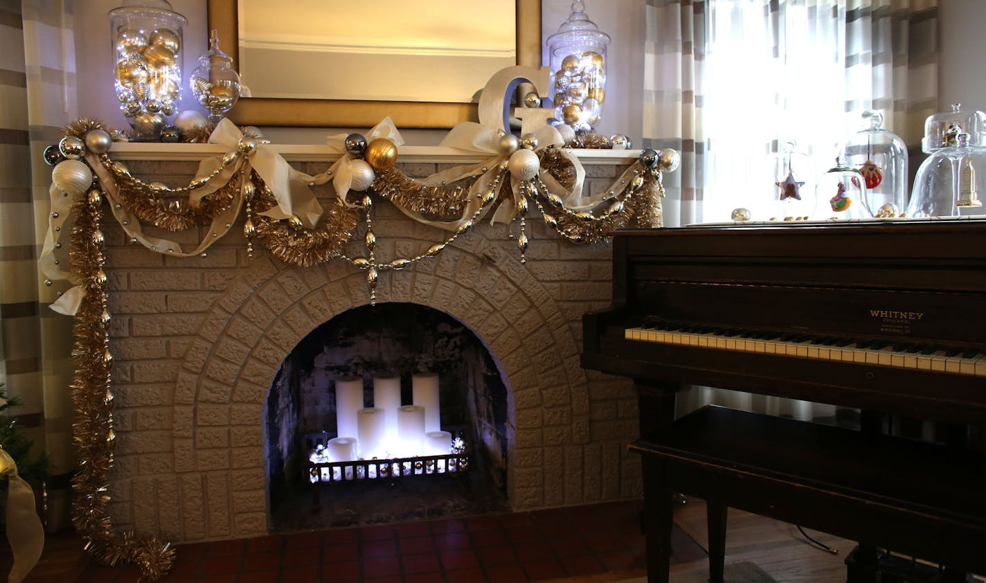 Lisa Peck trimmed her merry mantel with tinsel garlands, and ties silver, gold and pewter ornaments with cream ribbon. She uses strings of battery-powered lights for mood lighting.