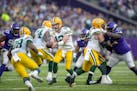 Packers quarterback Aaron Rodgers (12) passed the ball to Packers running back A.J. Dillon (28) during the third quarter, Sunday, Nov. 21, 2021 in Min