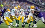 Packers quarterback Aaron Rodgers (12) passed the ball to Packers running back A.J. Dillon (28) during the third quarter, Sunday, Nov. 21, 2021 in Min