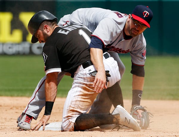 Twins second baseman Brian Dozier looked to first base after forcing out the White Sox's Adam Eaton during the fourth inning Thursday.