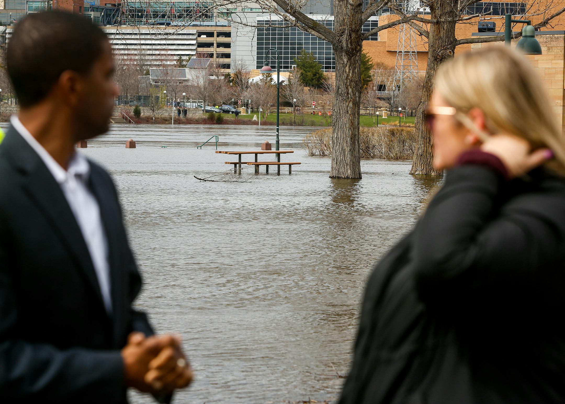 St. Paul Mayor Melvin Carter looks out over a flooded Harriet Island Regional Park while talking to a resident on Sunday, April 23, 2023.