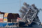 Explosive charges are detonated to bring down sections of the collapsed Francis Scott Key Bridge resting on the container ship Dali on Monday, May 13,