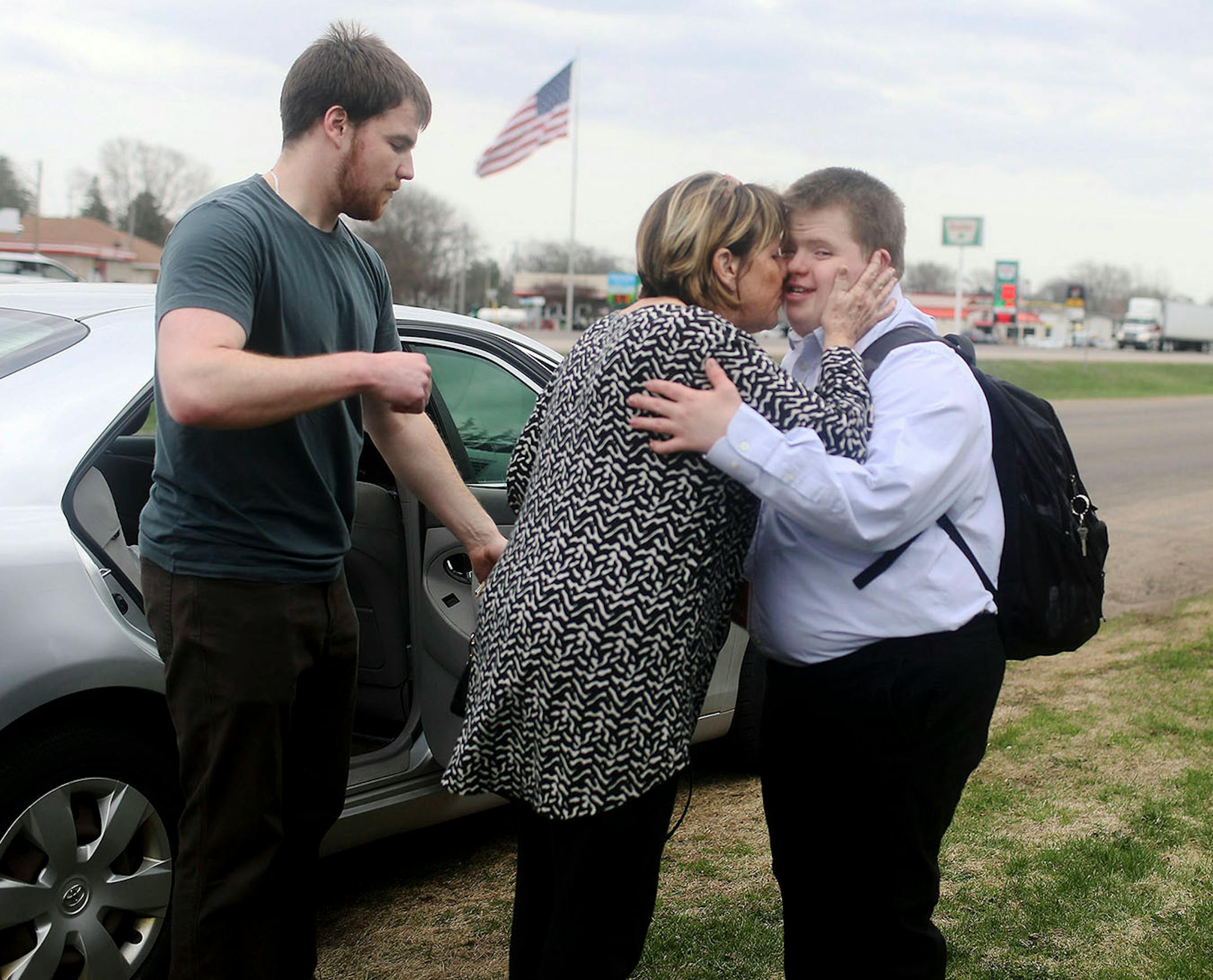 Charlie gets a hug from his mother Liz McGrory, while Charlie's brother Andy, who is also his job coach, looks on Tuesday, May 1, 2018, in Winona, MN.