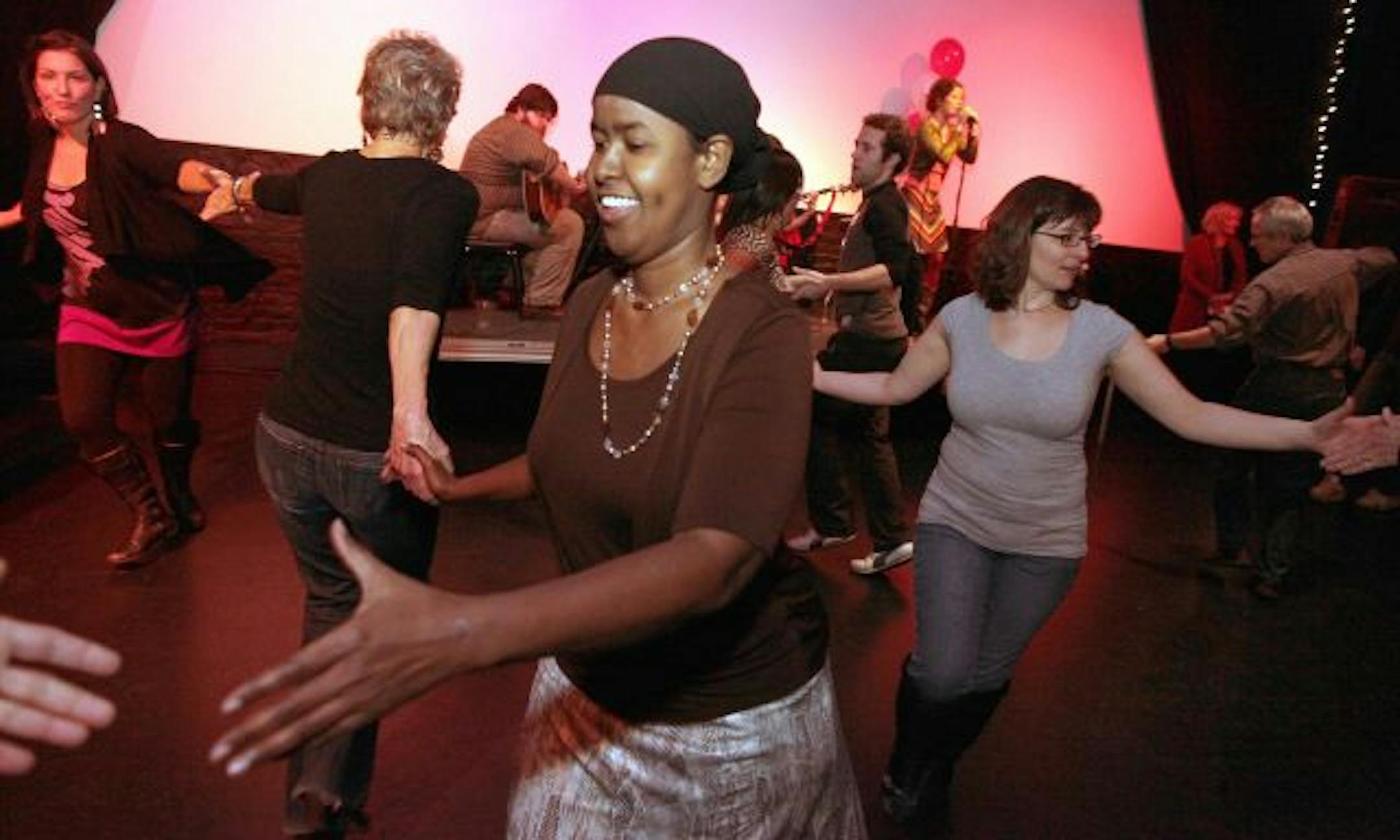 Ifrah Jimale swings with her partner at Julia Hutchinson's square-dance birthday bash.