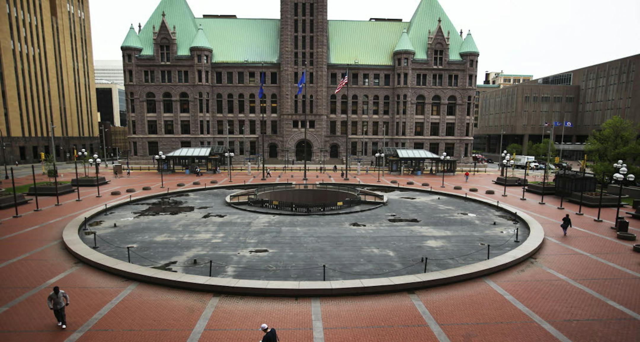 Pedestrians make their past the north plaza near the Government Center in Minneapolis in 2012.