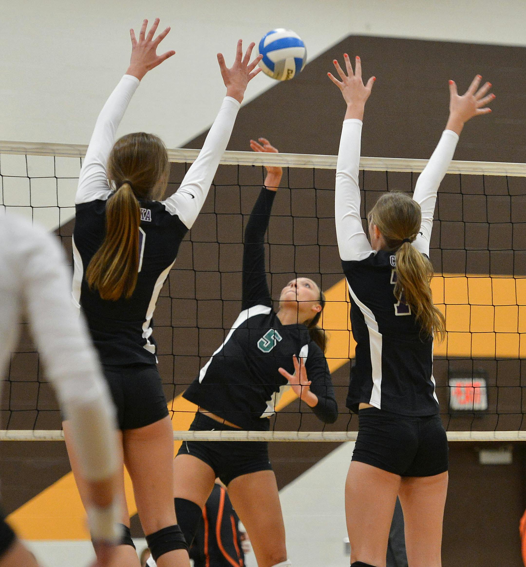 Eagan's Taylr McNeil spikes the ball through Chaska's defense during a semifinal match of the Apple Valley Eagle Invitational Saturday, September 21 at Apple Valley High School. Eagan went on the the championship match of the tournament. ] (SPECIAL TO THE STAR TRIBUNE/BRE McGEE) **Taylr McNeil (5) ORG XMIT: MIN1309211605251130