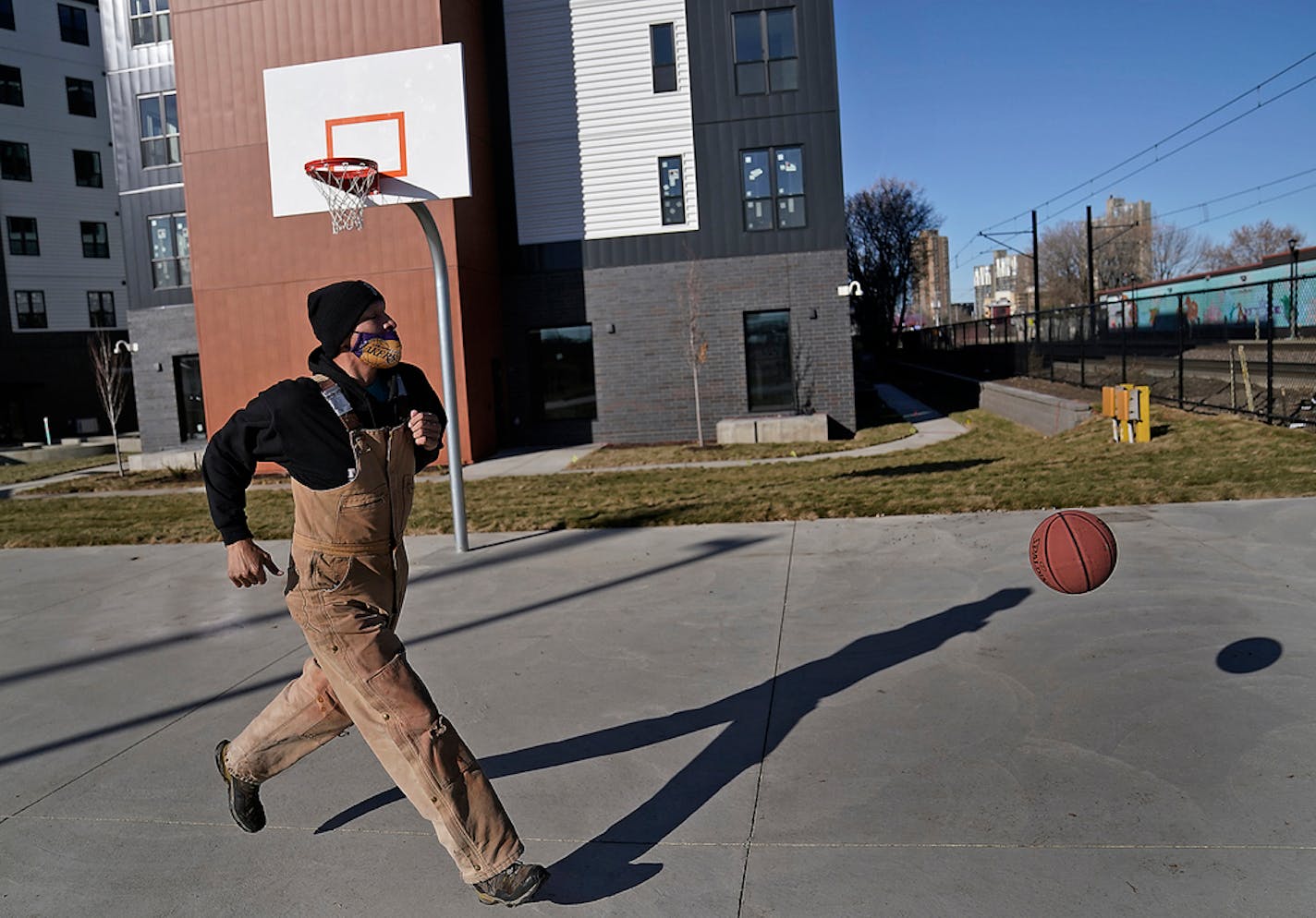 Allen Touche, 48, stopped at the new, yet to open Red Lake Nation apartment complex recently to shoot some hoops on his weekly Saturday journey to help feed homeless Natives and others in Minneapolis. The low-rent complex targeted specifically to Native Americans is located across from the Wall of Forgotten Natives, where last summer Touche lived in a tent. Touche, after many attempts, got a job working construction at the couplex called Mino-bimaadiziwin, in Ojibwe for "the good life". In early 2021 he will move in to his own place there. "I put my blood, sweat and tears into this place," he said during a recent visit to the complex. "My own physical labor built this building." ]