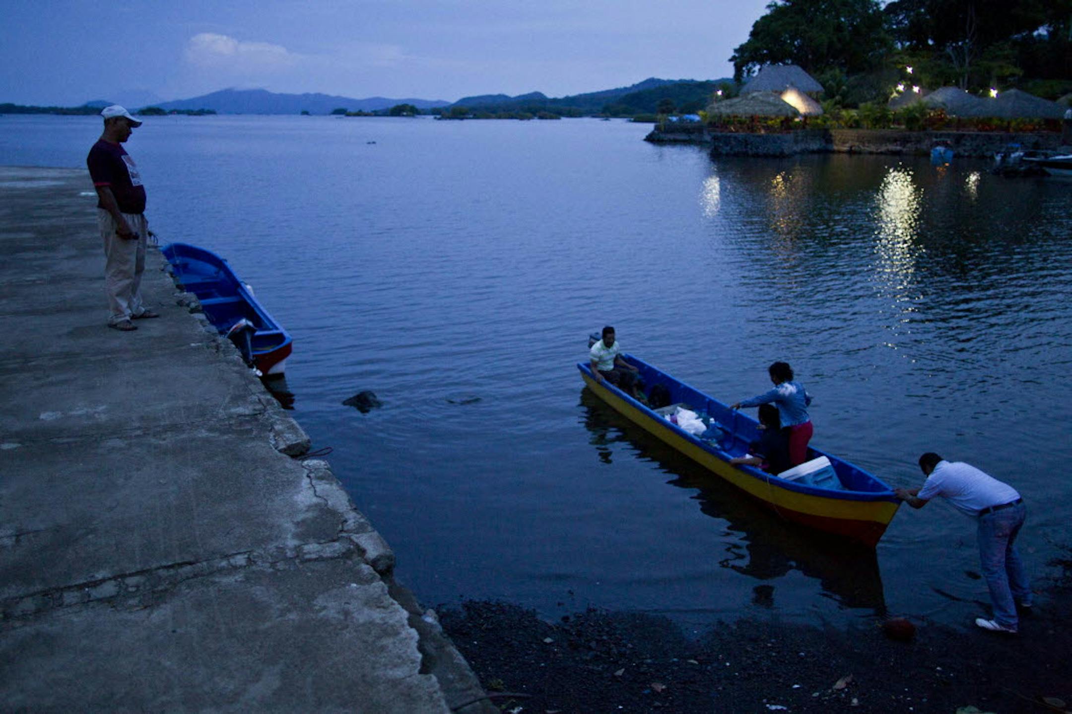 People push a boat into Lake Nicaragua, near Granada, Nicaragua. A multi-billion dollar Chinese plan to plow a massive rival to the Panama Canal across the middle of Nicaragua was approved Thursday by the leftist-controlled National Assembly.