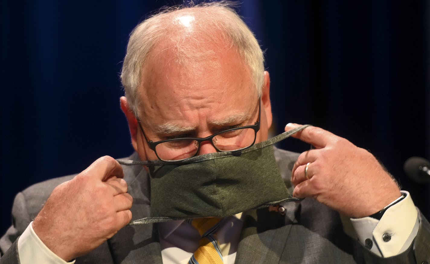 Minnesota Gov. Tim Walz put his face mask at the conclusion of a press conference Thursday, July 30, 2020 announcing the learning plan for Minnesota schools for the upcoming 2020-21 school year. (Aaron Lavinsky/Star Tribune via AP, Pool)