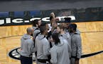Minnesota Timberwolves players huddle on the court after player introductions before an NBA basketball game against the Orlando Magic, Sunday, May 9, 