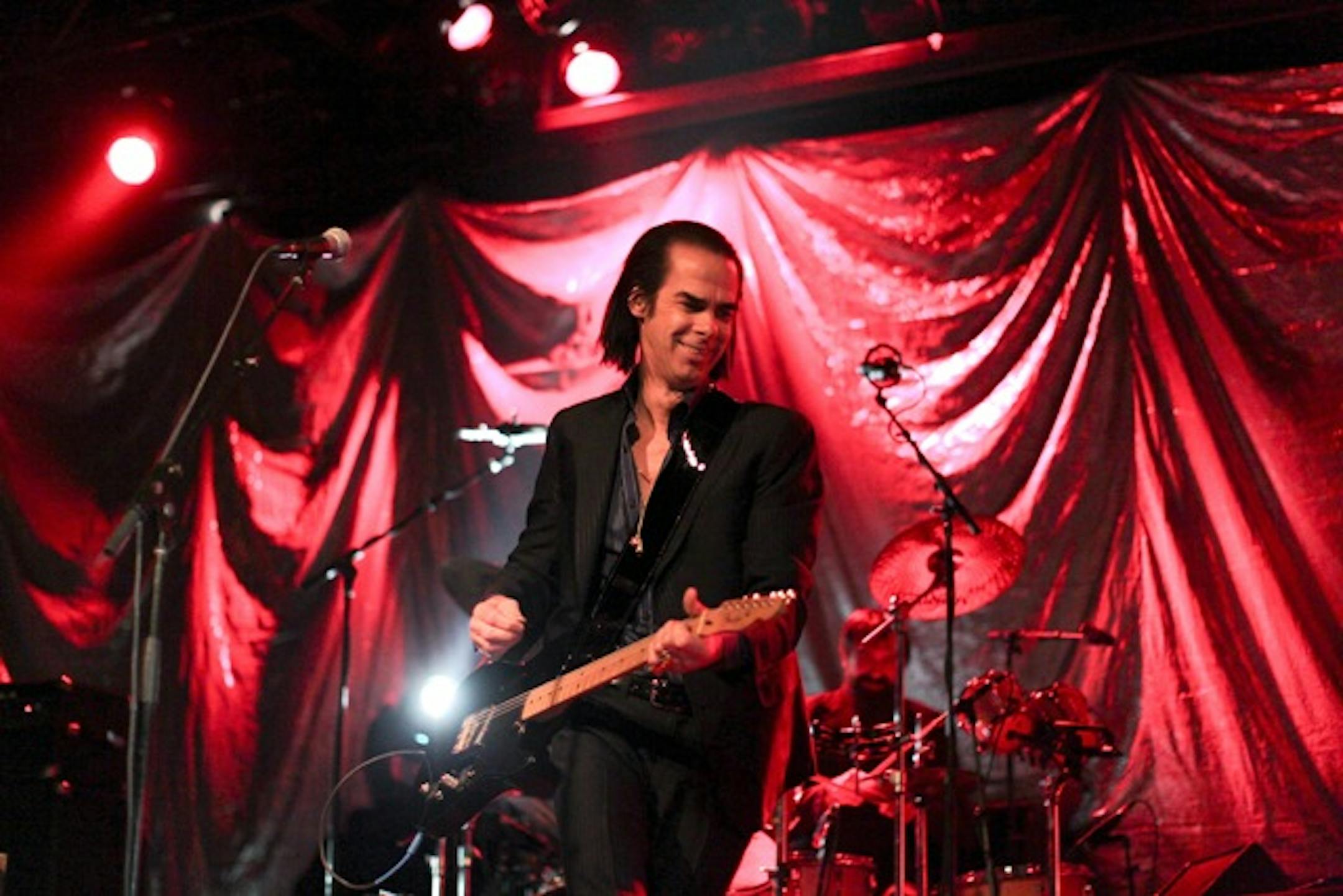 Nick Cave broke into a rare smile Tuesday at First Avenue.