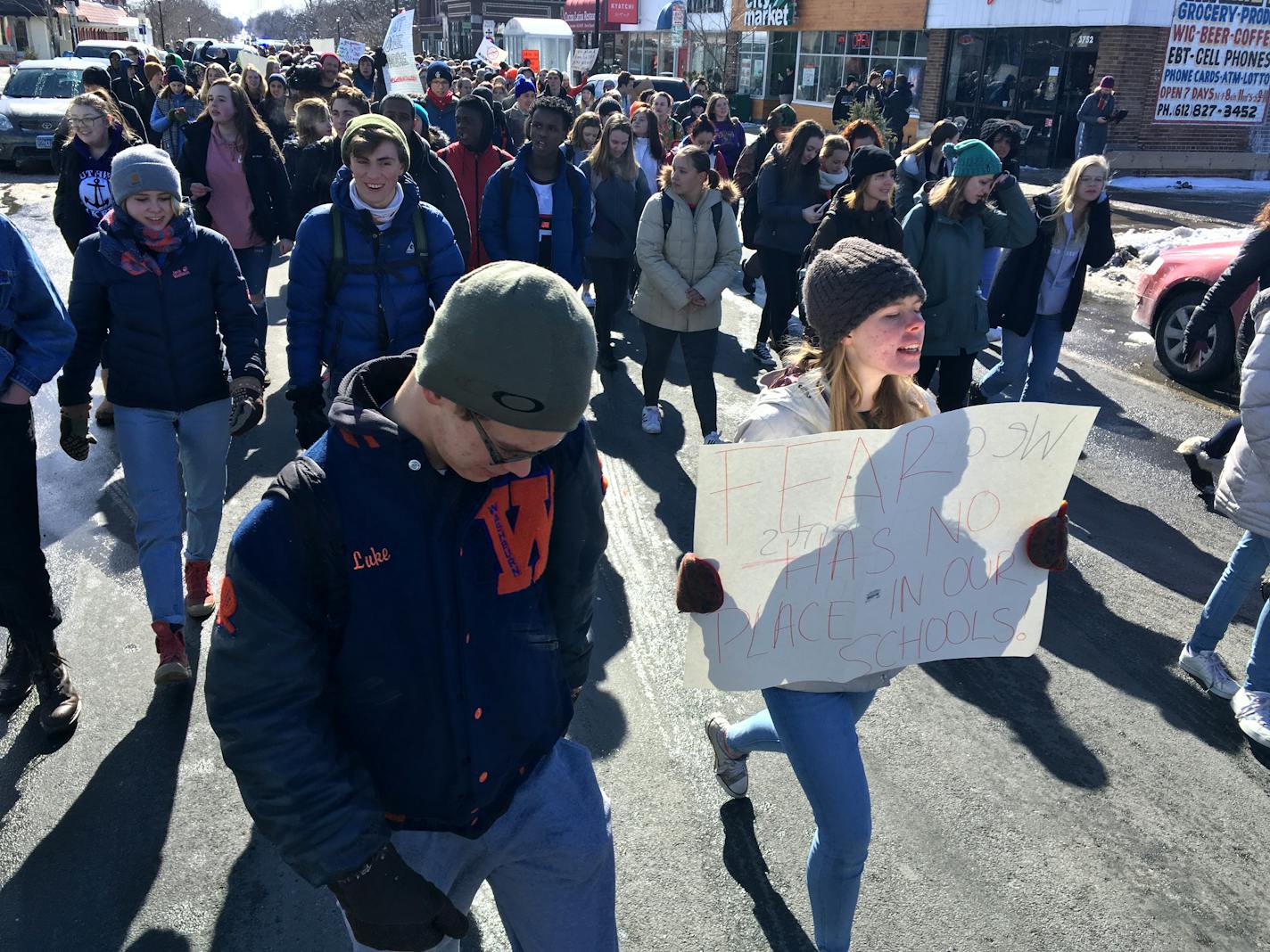 Minneapolis high school students make their way to City Hall after walking out of school Wednesday.