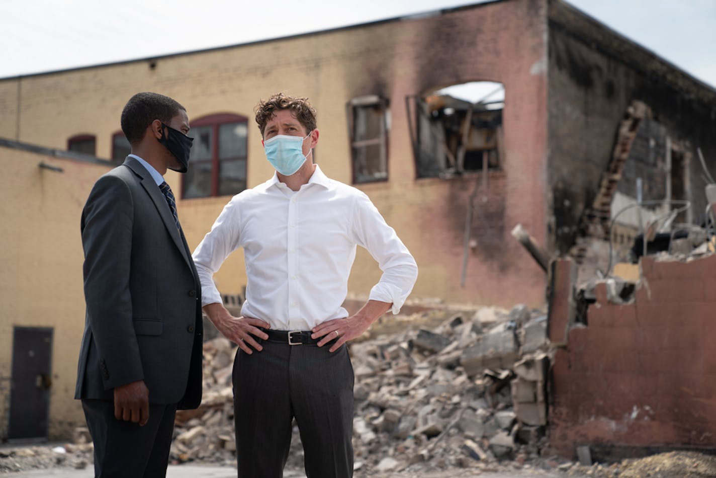 Minneapolis Mayor Jacob Frey and St. Paul Mayor Melvin Carter talked after a news conference near the burned-out Foot Locker on E. Lake Street in Minneapolis on June 15.