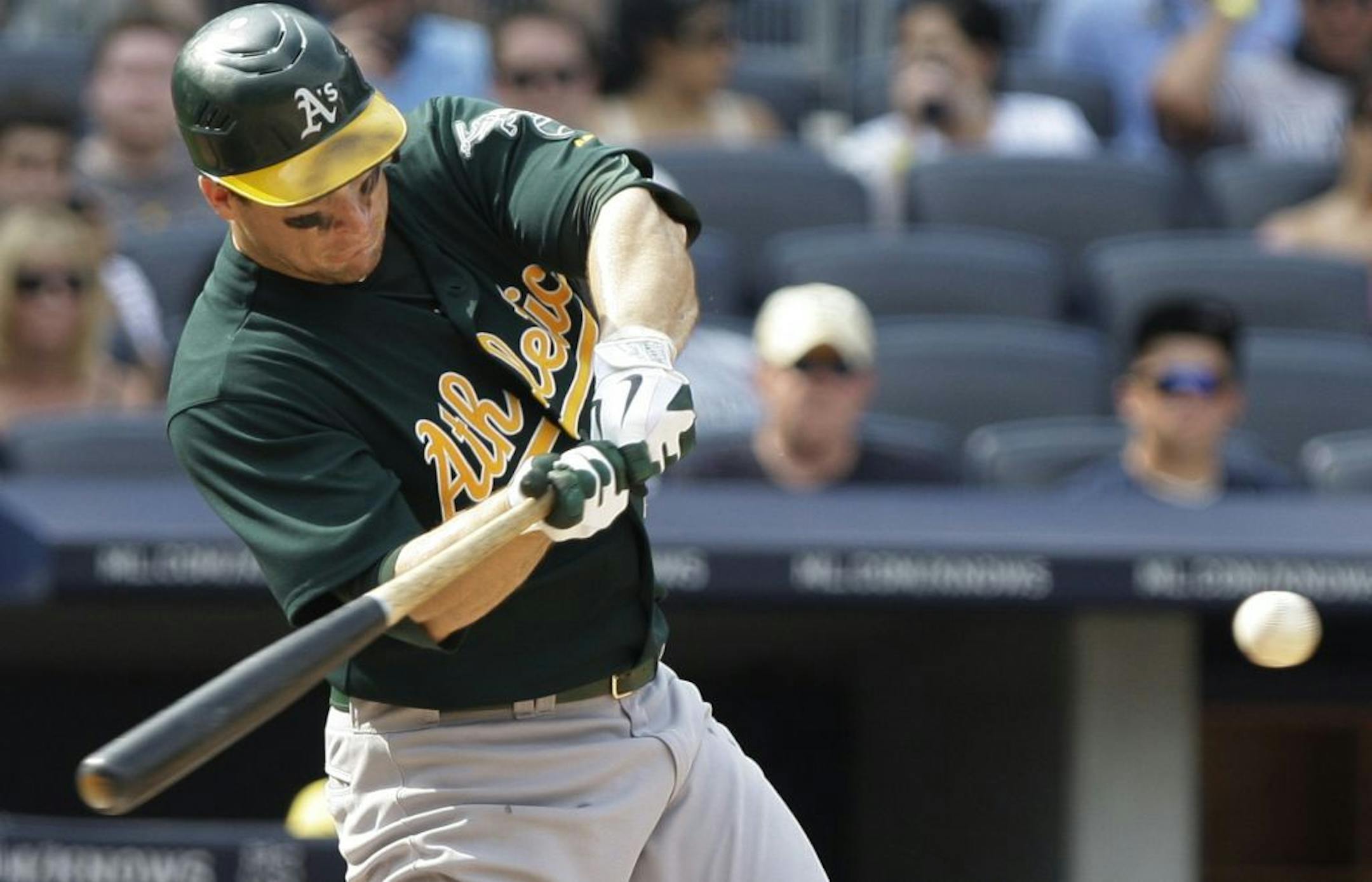 Oakland Athletics' Josh Willingham hits a single during the ninth inning of a baseball game against the New York Yankees Saturday, July 23, 2011, at Yankee Stadium in New York. The Athletics won the game 4-3.