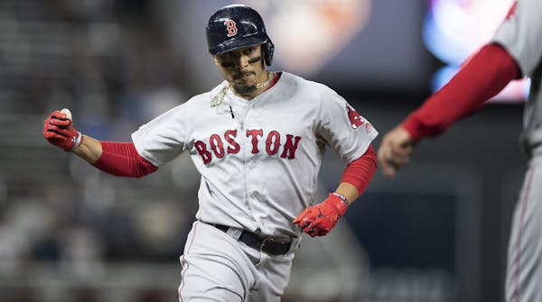 Boston Red Sox right fielder Mookie Betts (50) rounded the bases after hitting a home run against the Twins last season.