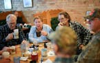 Clockwise from left, Frank Dolezal, Joy Schober, Kim Jungroth, Bill Zacharda and others eat breakfast at Old Main Eatery in Elk River, discussing the 