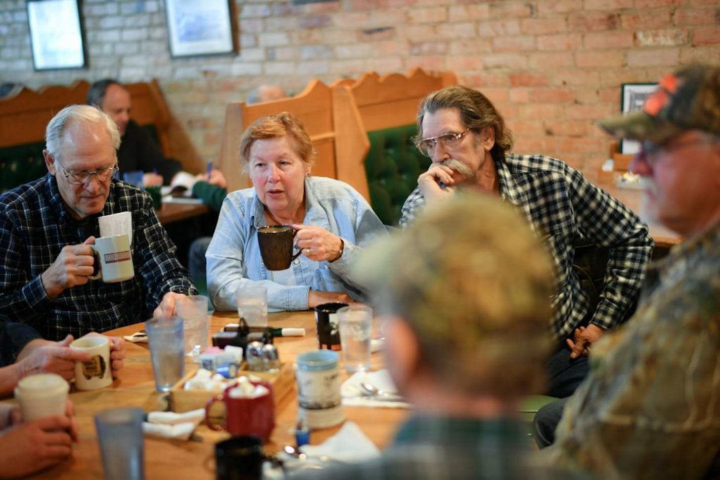 Clockwise from left, Frank Dolezal, Joy Schober, Kim Jungroth, Bill Zacharda and others eat breakfast at Old Main Eatery in Elk River, discussing the latest health care proposal.