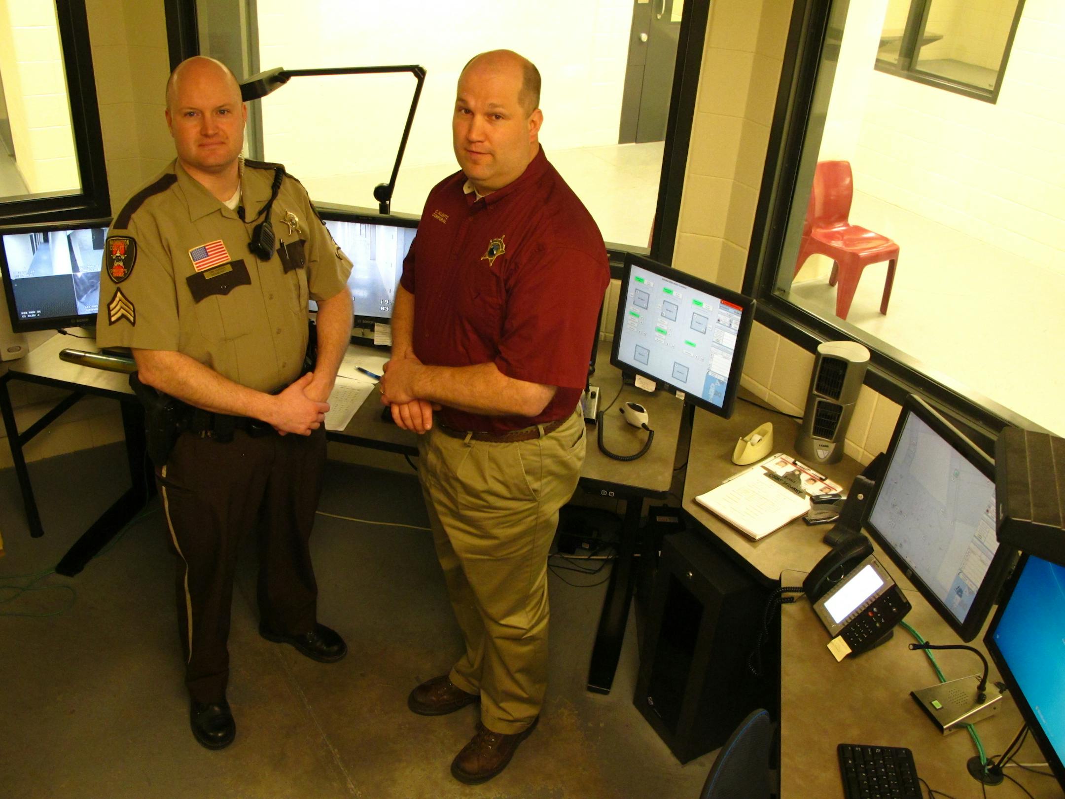 Sgt. Tim Harris, left, and Cpl. Chanin Klontz, shown in the courthouse command center, were injured in separate assaults. Trouble can start anywhere, inside and outside Washington County's 16 courtrooms.