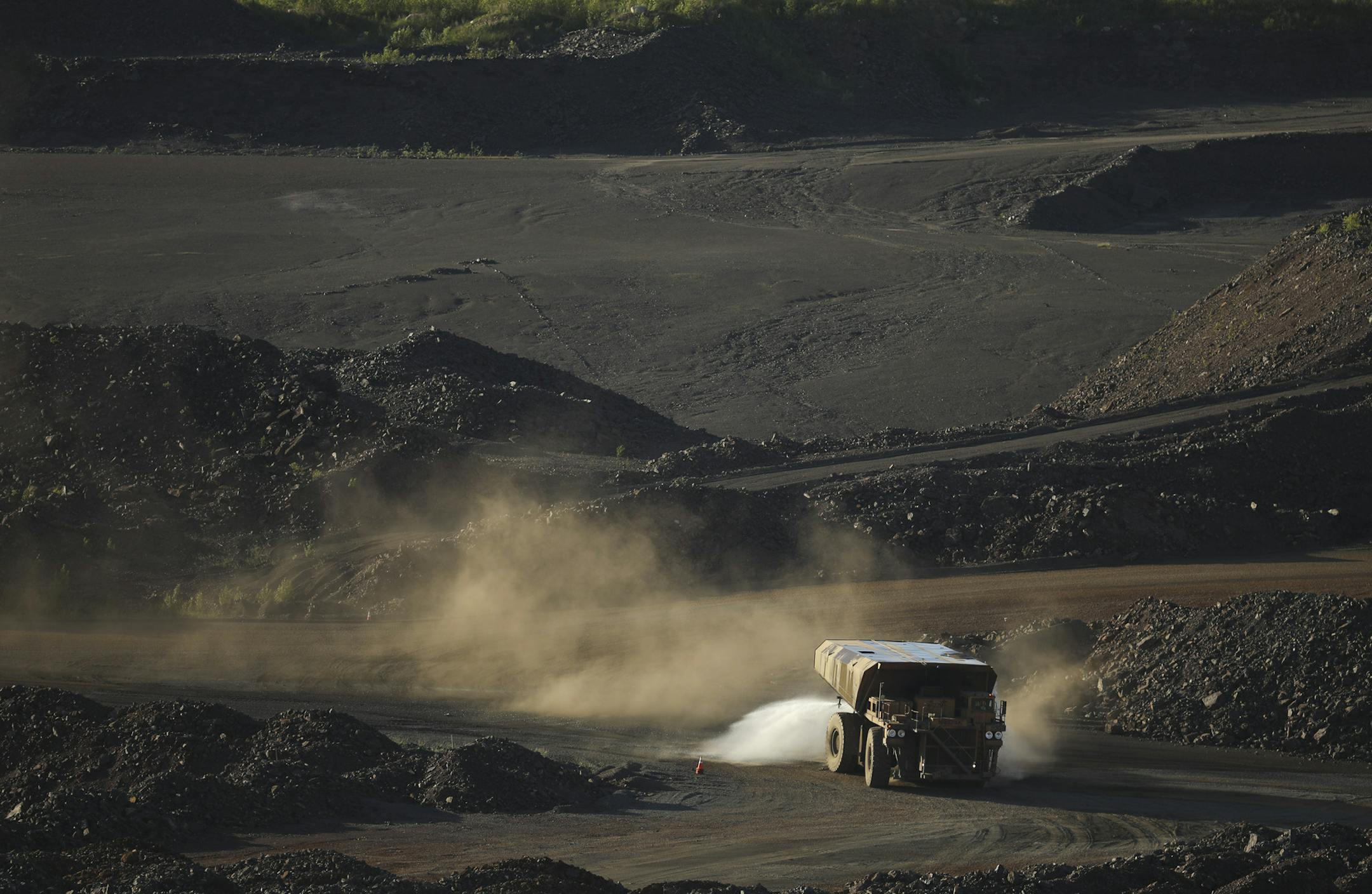 PART OF HIBBING TACONITE//A truck sprayed water on a road in part of theHull-Rust-Mahoning Mine to keep dust down Wednesday evening in Hibbing. ] JEFF WHEELER &#xef; jeff.wheeler@startribune.com The economy on the Iron Range is in a boom cycle currently with mines operating and new business betting on the current upswing lasting. The Boomtown Brewery & Woodfire Grill was photographed during the busy Wednesday dinner rush on June 13, 2018 in downtown Hibbing.