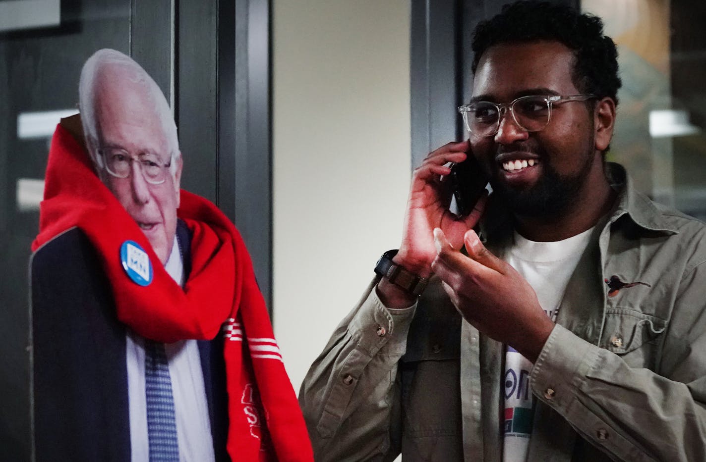 Yafiet Bezabih made a phone call while standing to a cardboard cutout of Bernie Sanders inside the TakeAction Minnesota offices in St. Paul. ] Shari L. Gross &#xa5; shari.gross@startribune.com TakeAction Minnesota volunteers texted and phone banked for Bernie Sanders campaign in St. Paul, Minn. on Wednesday, Feb. 12, 2020.