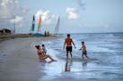FILE - Tourists are seen along the beach at the Iberostar Selection Varadero hotel in Varadero, Cuba, on Sept. 29, 2021. The Biden administration anno