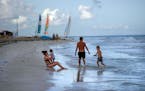 FILE - Tourists are seen along the beach at the Iberostar Selection Varadero hotel in Varadero, Cuba, on Sept. 29, 2021. The Biden administration anno
