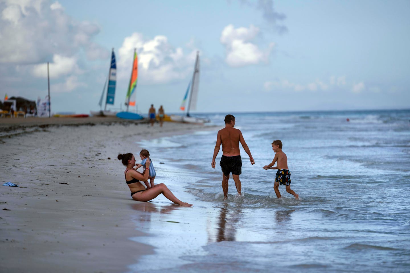 FILE - Tourists are seen along the beach at the Iberostar Selection Varadero hotel in Varadero, Cuba, on Sept. 29, 2021. The Biden administration announced Monday that it will expand flights to Cuba and lift Donald Trump-era restrictions on remittances that immigrants can send to people on the island. (AP Photo/Ramon Espinosa, File)