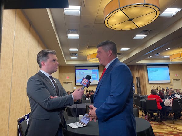 Congressman Brad Finstad, a southern Minnesota Republican, is interviewed by a local TV reporter at his election night party at the Courtyard by Marri