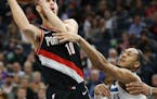 Portland Trail Blazers' Jake Layman, left, is fouled by former Timberwolves' player Cameron Reynolds in April.